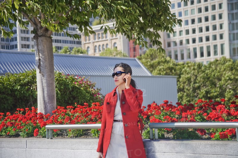 Asian businesswoman talking on cell phone outdoors