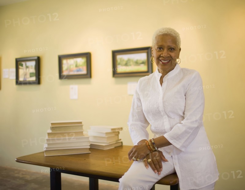 Black woman sitting on table