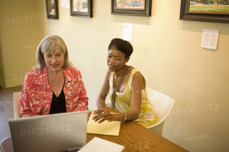 Women in gallery using laptop