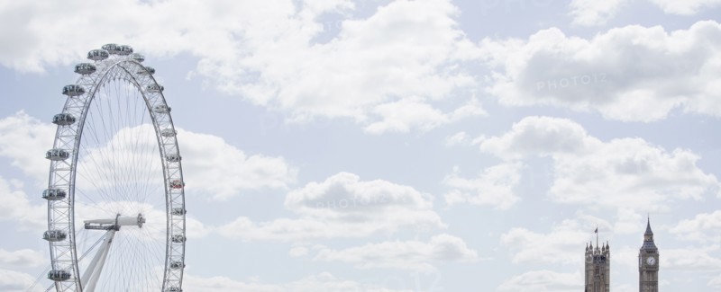 London Eye and clock towers in blue sky
