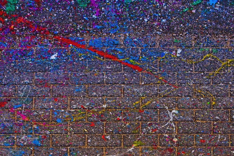 Splattered paint on brick wall