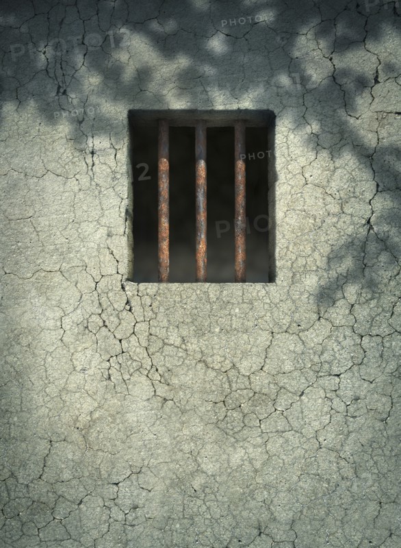 Bars on window of dilapidated wall