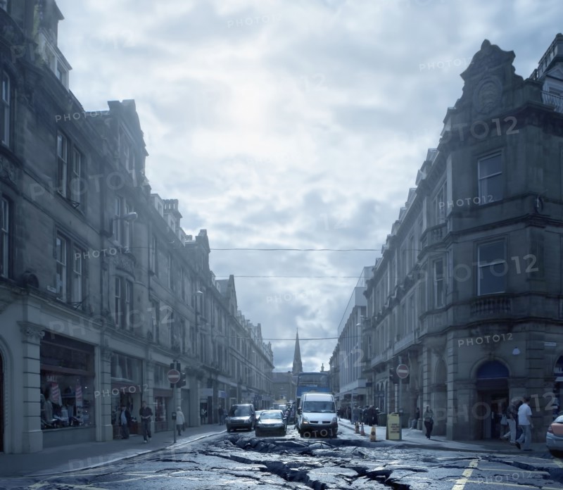 Cars driving on cracked urban pavement