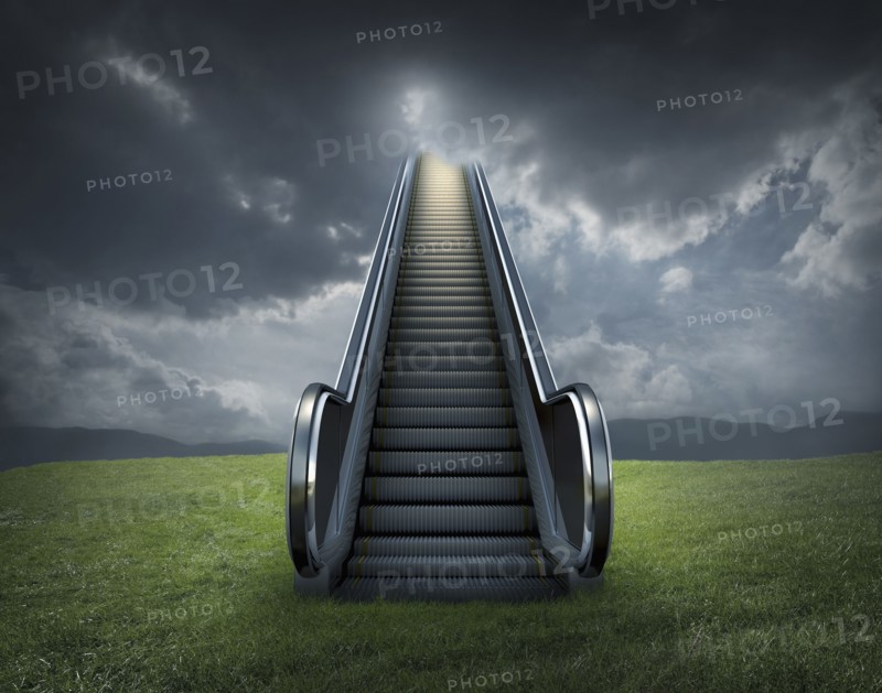 Escalator to cloudy sky in rural landscape