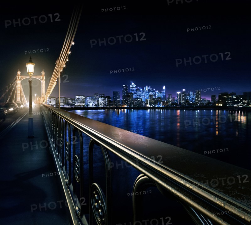 Railing on urban bridge at night