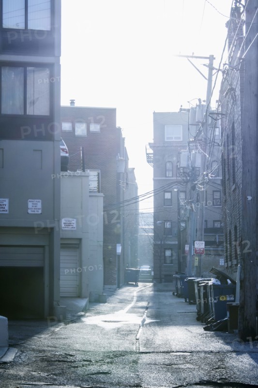 Garbage cans in urban alleyway