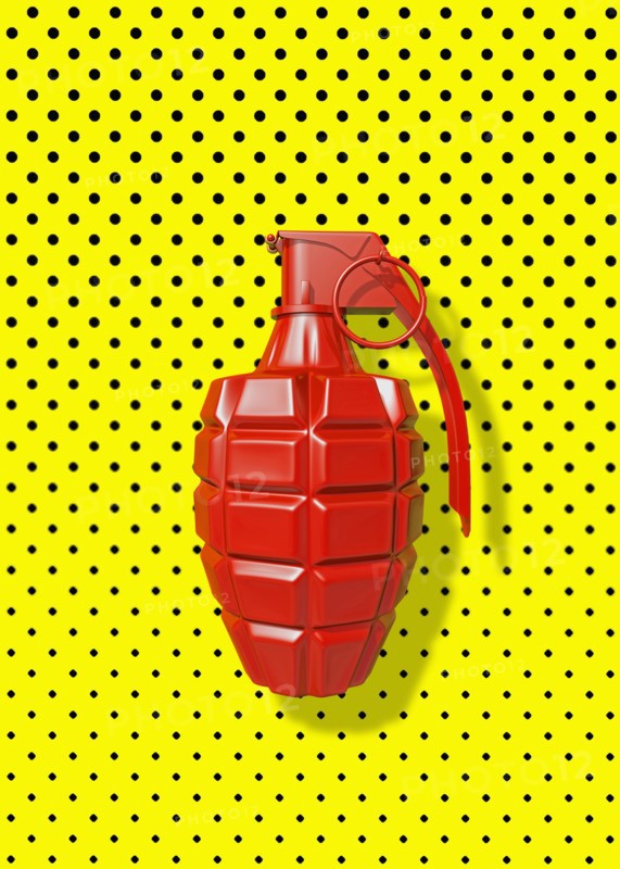 Close up of red grenade on polka dot background