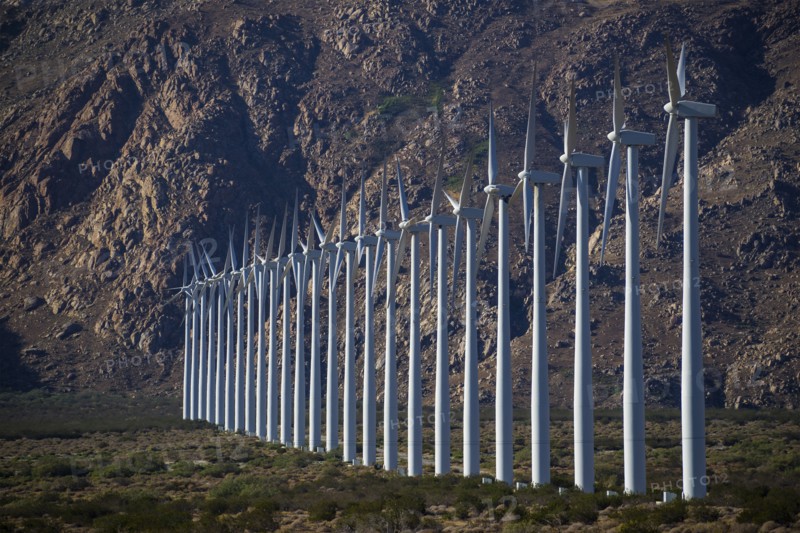 Row of wind turbines in rocky remote landscape
