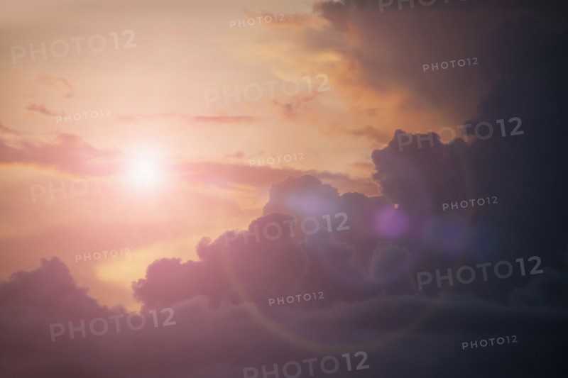 Sunbeams shining in cloudy sky
