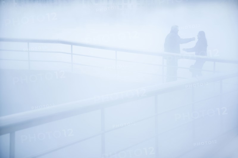 People standing on walkway in mist