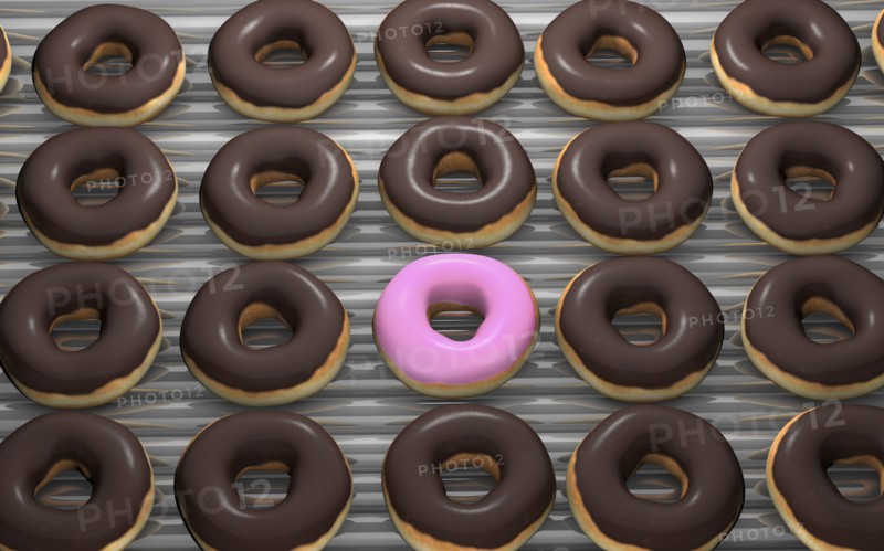 Close up of frosted donuts on baking pan