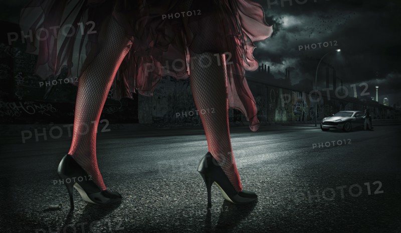 Woman wearing high heels on street at night