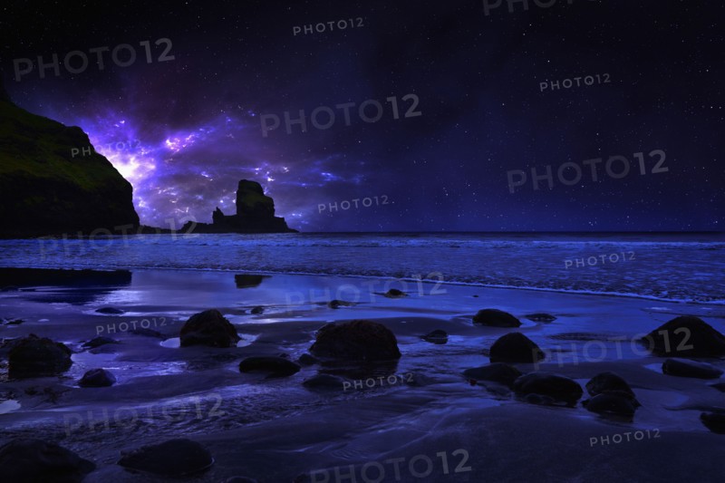 Night sky over rocky Carbost coastline