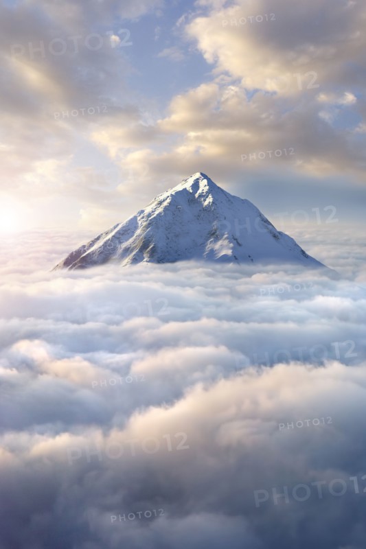 Snow-covered mountaintop above clouds