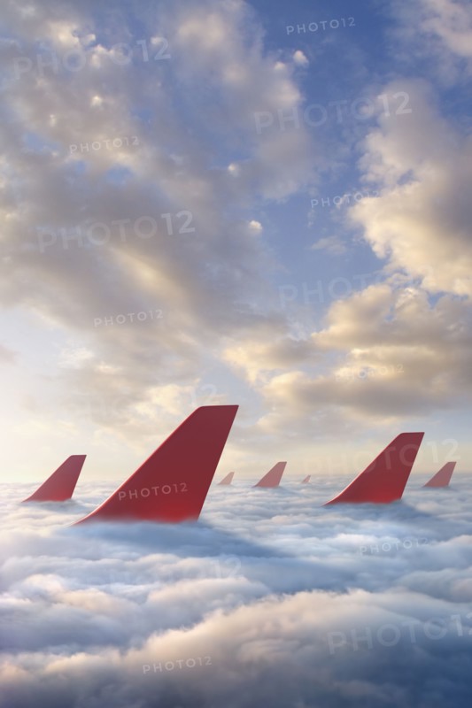 Airplane rudders above clouds