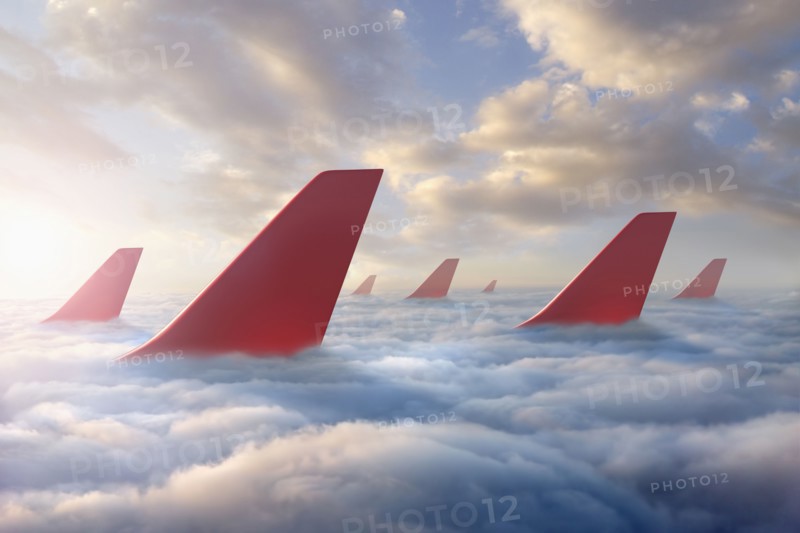 Airplane rudders above clouds
