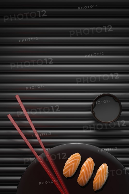 Chopsticks and sushi on round plate with dipping sauce