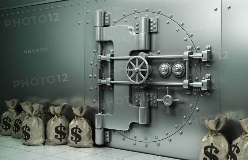 Money bags with dollar symbol on floor near vault