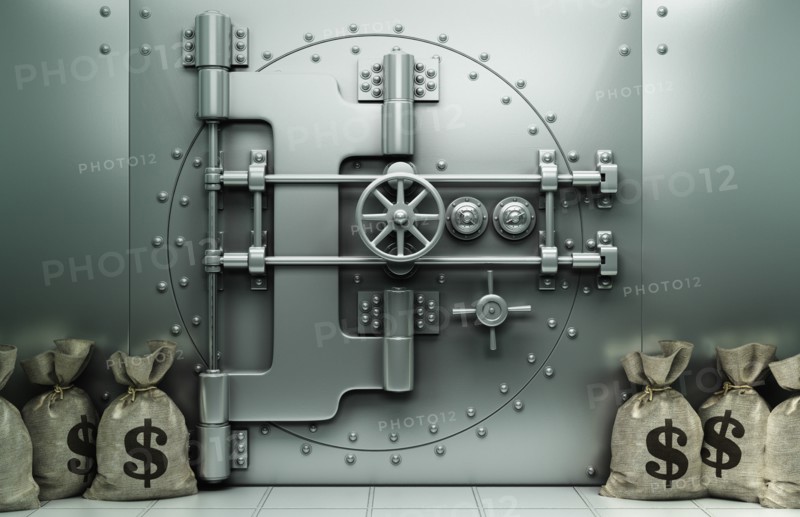 Money bags with dollar symbol on floor near vault