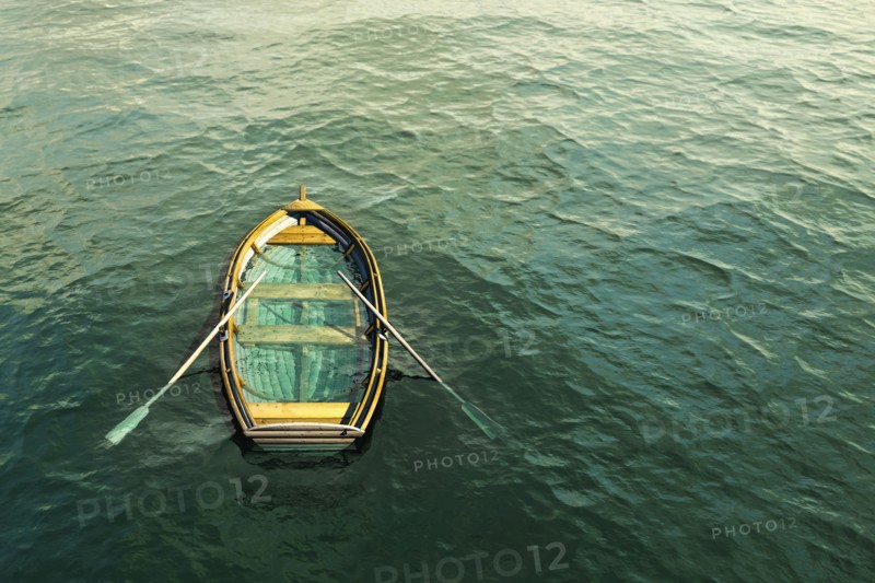 Abandoned sinking rowboat in ocean