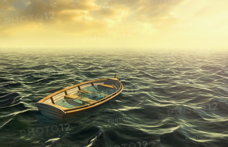 Abandoned sinking rowboat in ocean