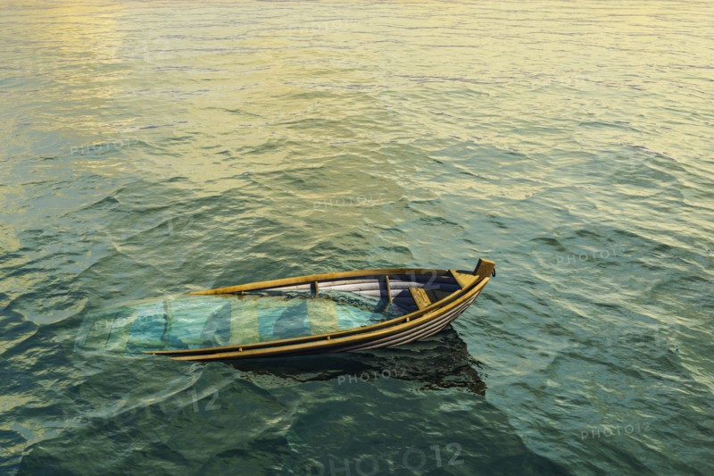 Abandoned sinking rowboat in ocean
