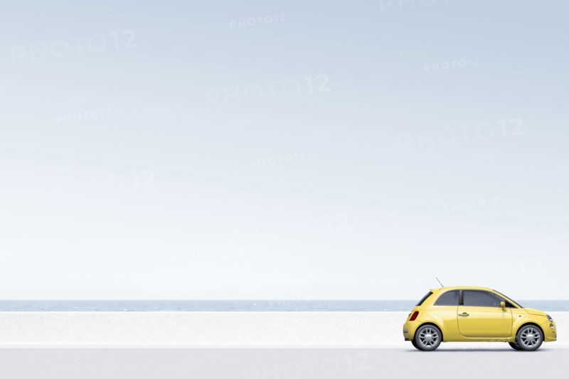 Yellow car near ocean