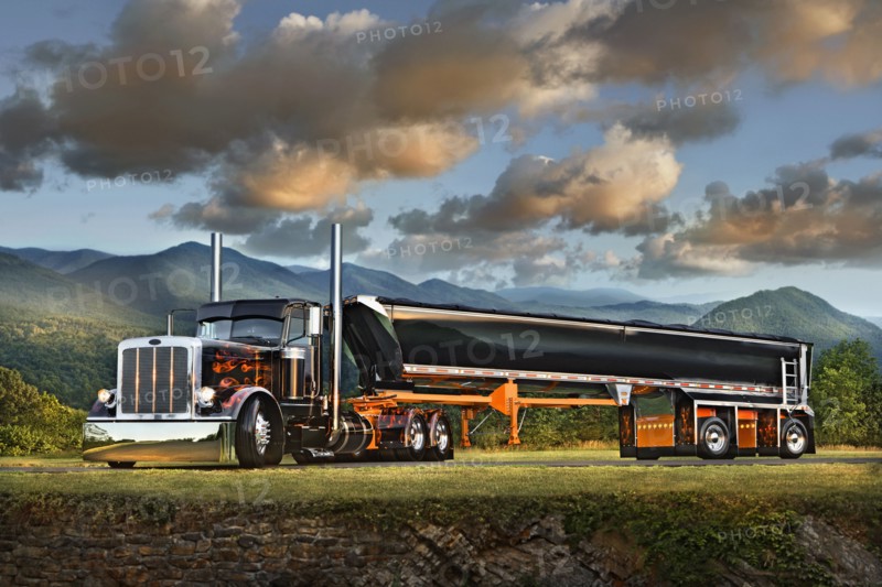 Semi-truck driving near mountain range