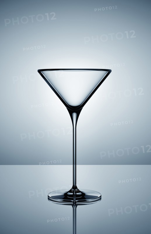 Empty martini glass on gray background