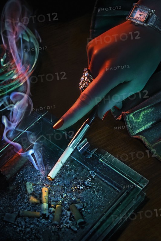 Hand of glamorous woman smoking cigarette