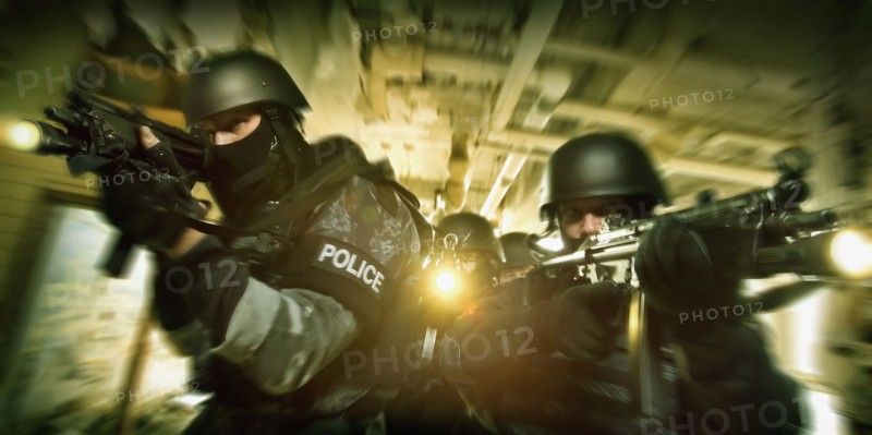 Police on the move aiming rifles