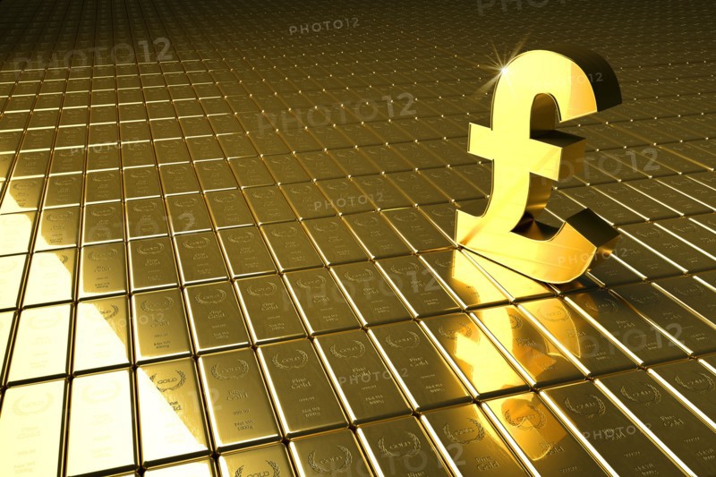 High angle view of gold bars and British pound symbol