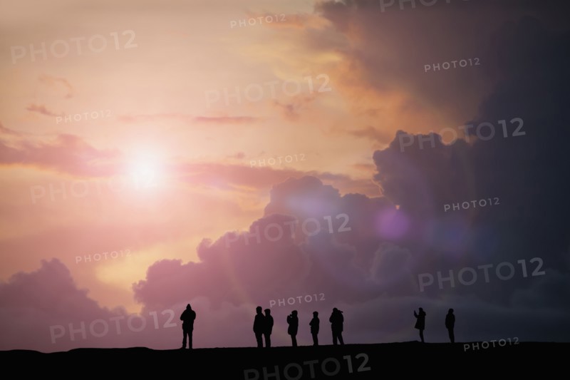 Silhouette of people watching sunset