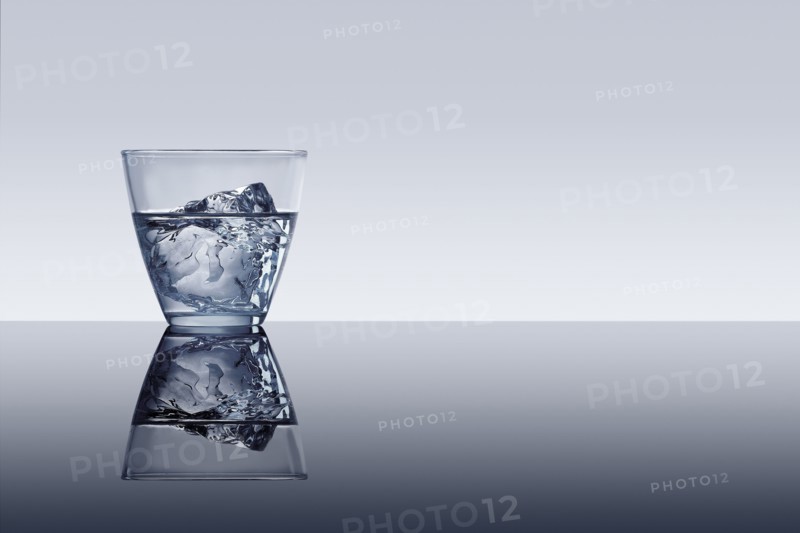 Ice cube in glass of water