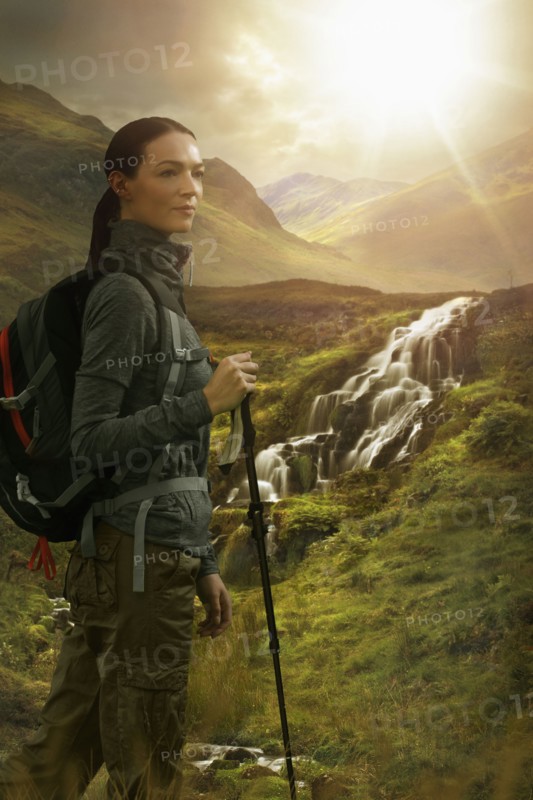 Caucasian woman hiking near waterfall