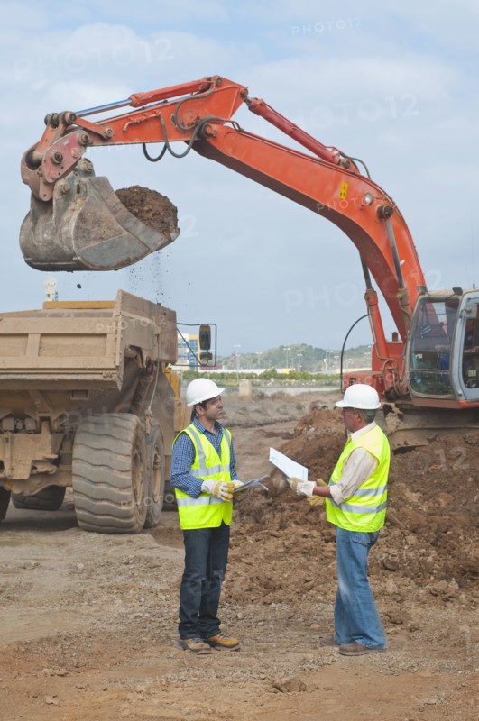 Hispanic construction workers talking on construction site