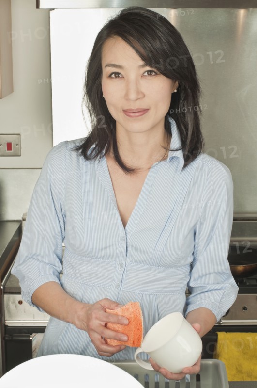 Korean woman washing dishes