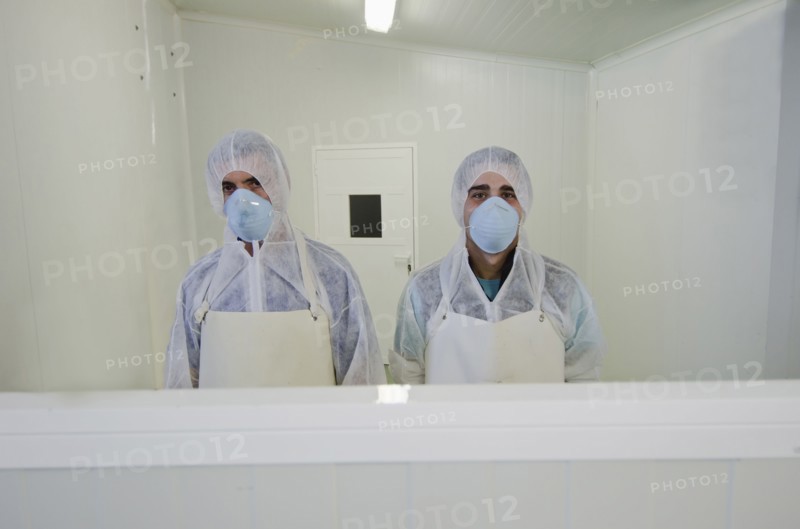 Hispanic workers in protective clothing