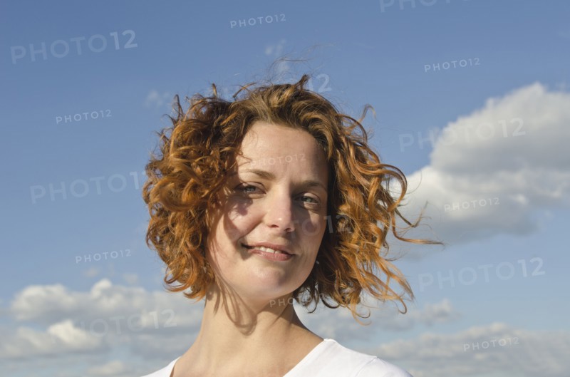 A young red-haired woman outdoors