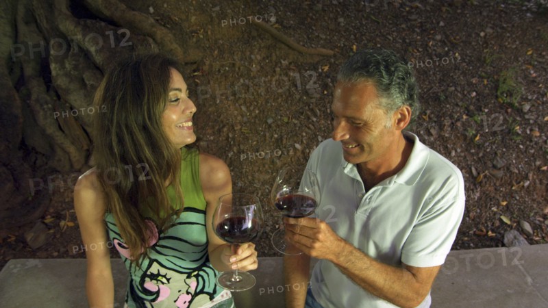 Couple drinking red wine in outdoors setting