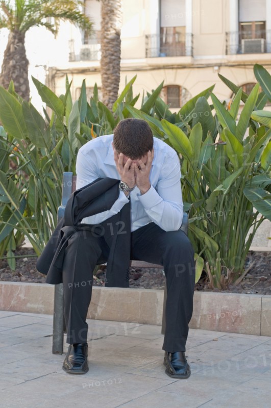 distraught man on park bench