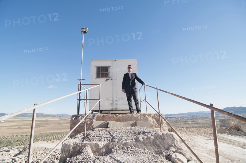 businessman in front of office container