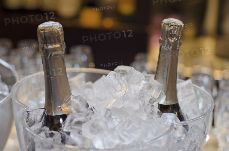 Wine bottles in ice bucket in restaurant
