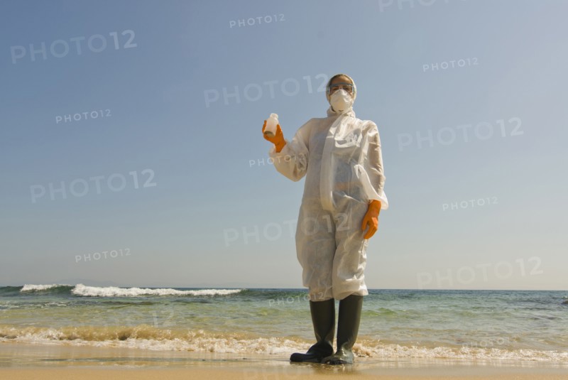 Woman in full-body protective clothing on beach