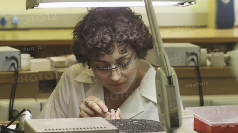 Female jeweller working on piece of jewellery