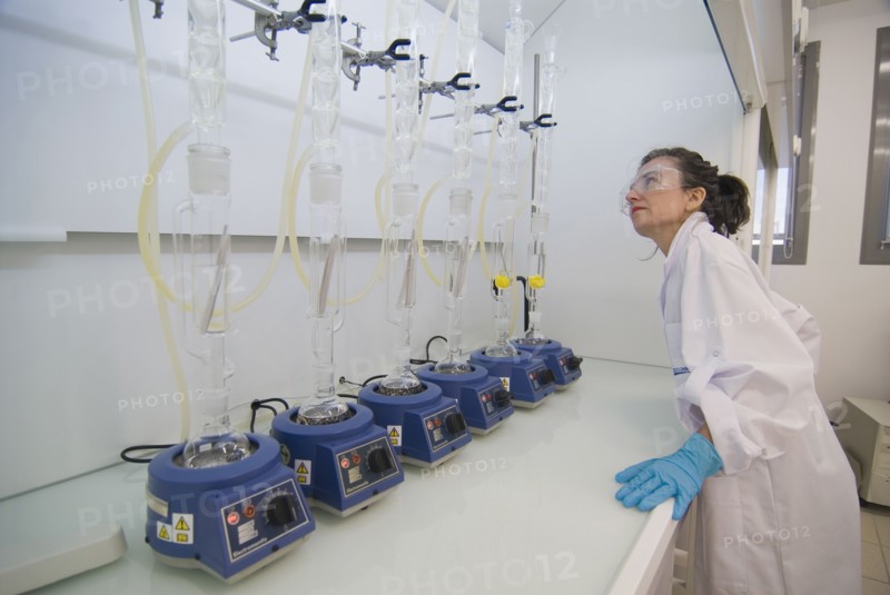 Female lab technician wearing safety glasses checking test array
