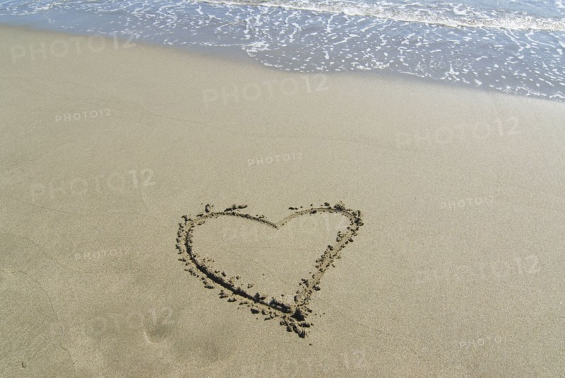 Spain Andalusia heart shape drawn in sand on beach