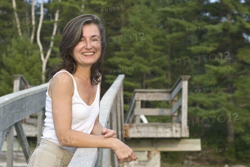 smiling woman on wooden walkway