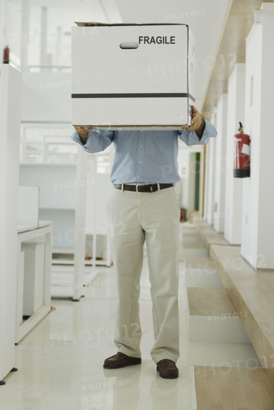 Man carrying box in office