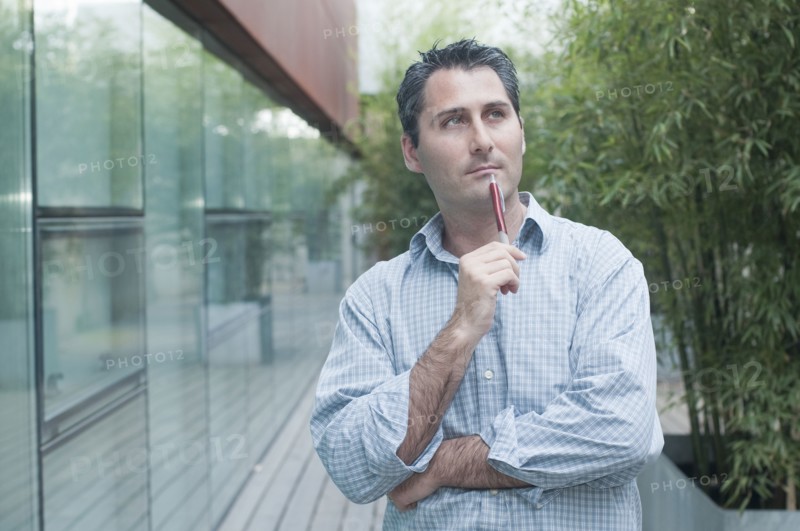young man looking pensively into distance